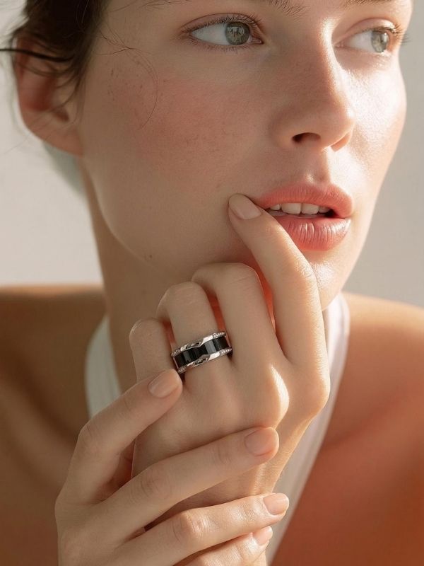 Primer plano de mano de femenina luciendo un anillo acero en el dedo anular.