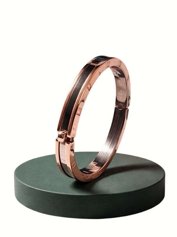Pulsera rígida articulada en acero inoxidable oro rosa canto plateado diseño italiano.