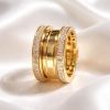 Anillo Acero tres bandas circonitas dorado